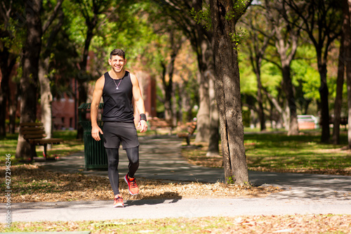 Man smiling in park while exercising