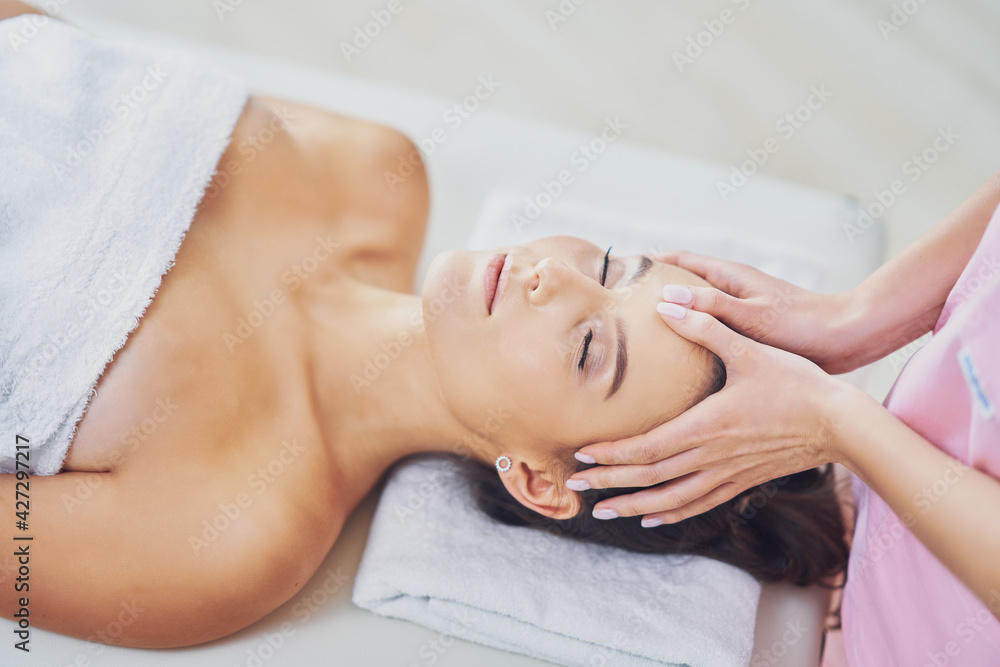 Adult woman during relaxing massage in spa Adult woman during relaxing massage in spa