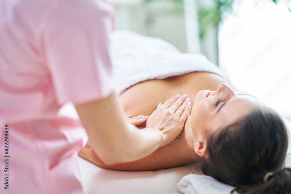 Adult woman during relaxing massage in spa Adult woman during relaxing massage in spa