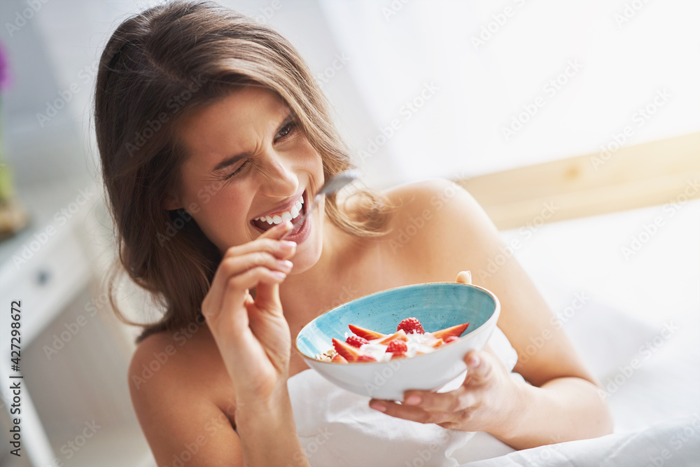 Young woman in underwear eating cereals Young woman in underwear eating cereals