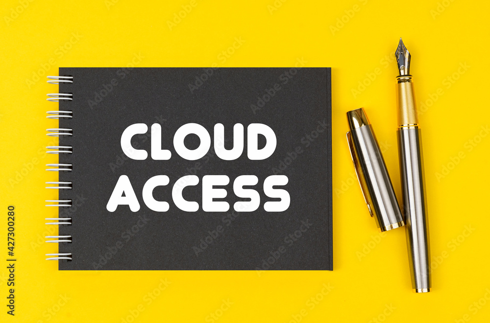 On a yellow background lies a pen and a black notebook with the inscription - Cloud Access On a yellow background lies a pen and a black notebook with the inscription - Cloud Access