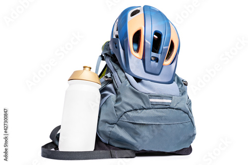 Protective helmet, backpack and water bottle, isolated on white background. Set of mountain biking accessories. Accessories for cycling.
