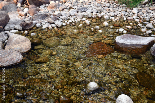Photos Shallow water with stones in different sizes