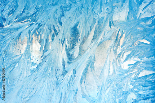 frosty patterns on the window glass closeup. natural textures and backgrounds. ice patterns on frozen