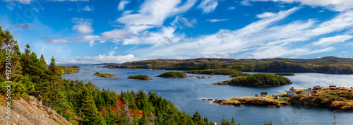 Panoramic View of a Canadian Landscape and a small town on the Atlantic Ocean Coast. Colorful Blue Sky Art Render. Taken in Pikes Arm, Newfoundland and Labrador, Canada.