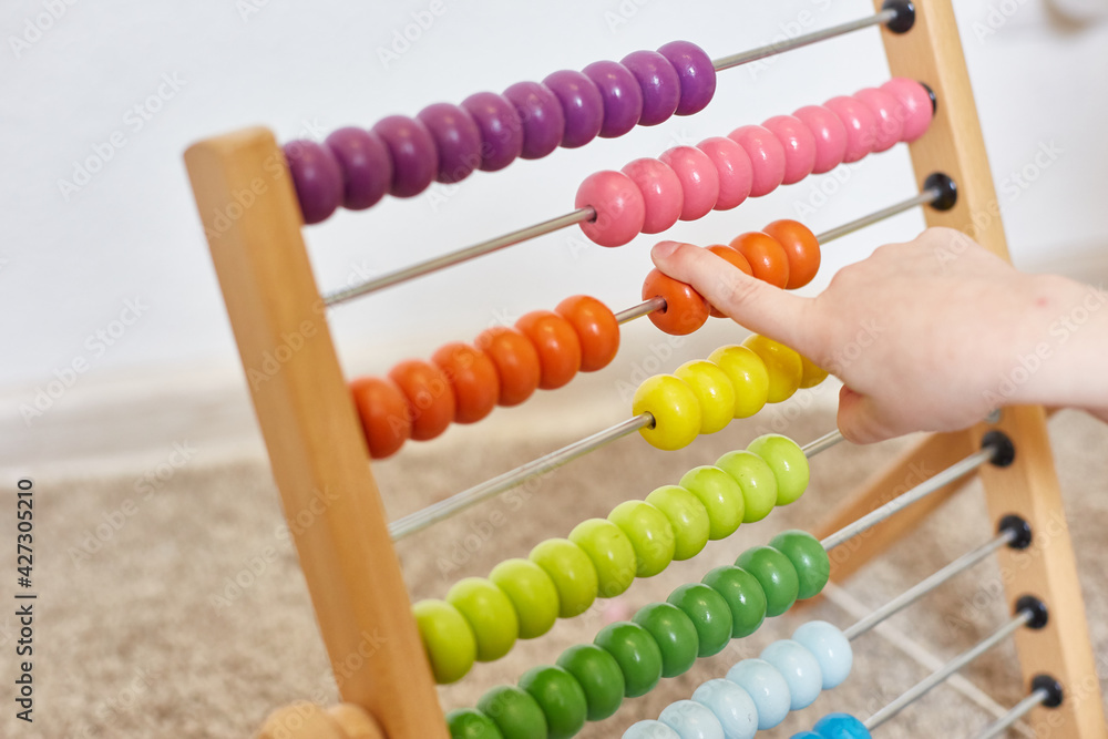 the child learns to count from children's accounts. A child's hand slides over the bills. Education of children. the child learns to count from children's accounts. A child's hand slides over the bills. Education of children.