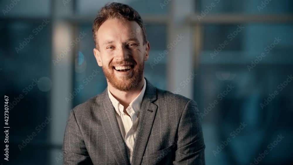 close-up portrait of a smiling young man in the office with panoramic windows with night city view close-up portrait of a smiling young man in the office with panoramic windows with night city view