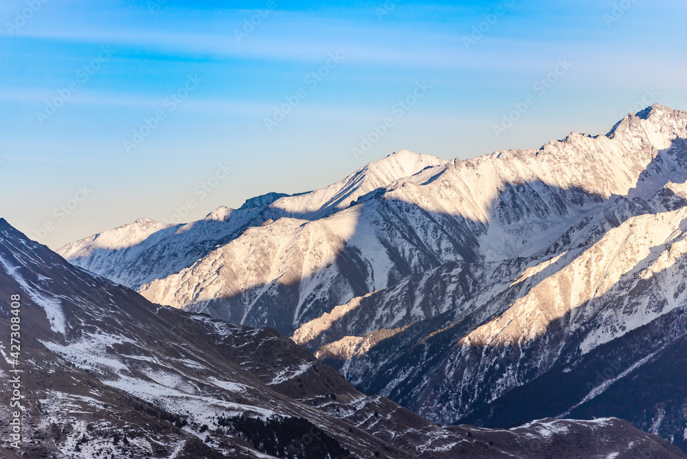 Elbrus region in the sunlight. A large valley among the steep Caucasus mountains.