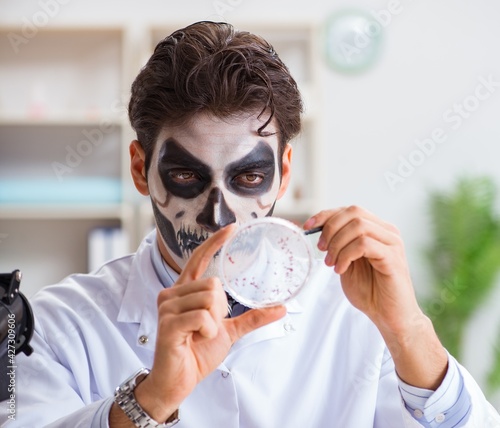 Scary monster doctor working in lab photo