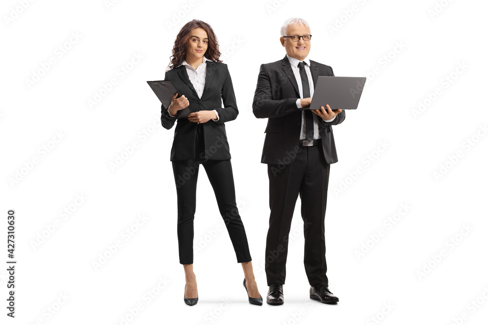 Mature businessman with a laptop and a young professional woman standing next to him Mature businessman with a laptop and a young professional woman standing next to him
