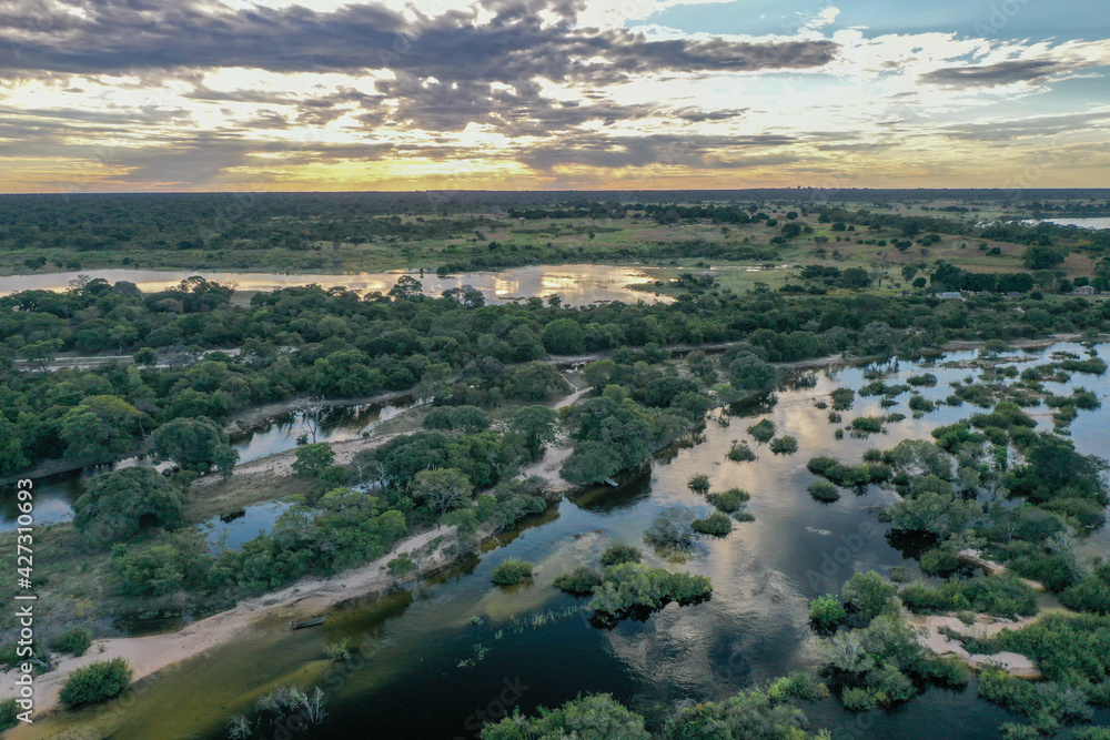 Fototapeta premium Wide aerial view of the Zambezi river in Zambia in flood with sunset in the background.