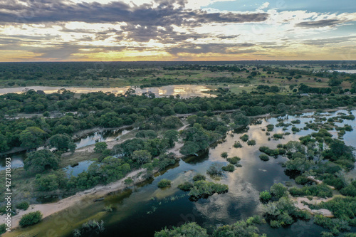 Wide aerial view of the Zambezi river in Zambia in flood with sunset in the background.