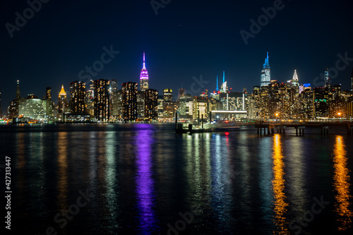 The lights of Midtown Manhattan reflected into the East River at night