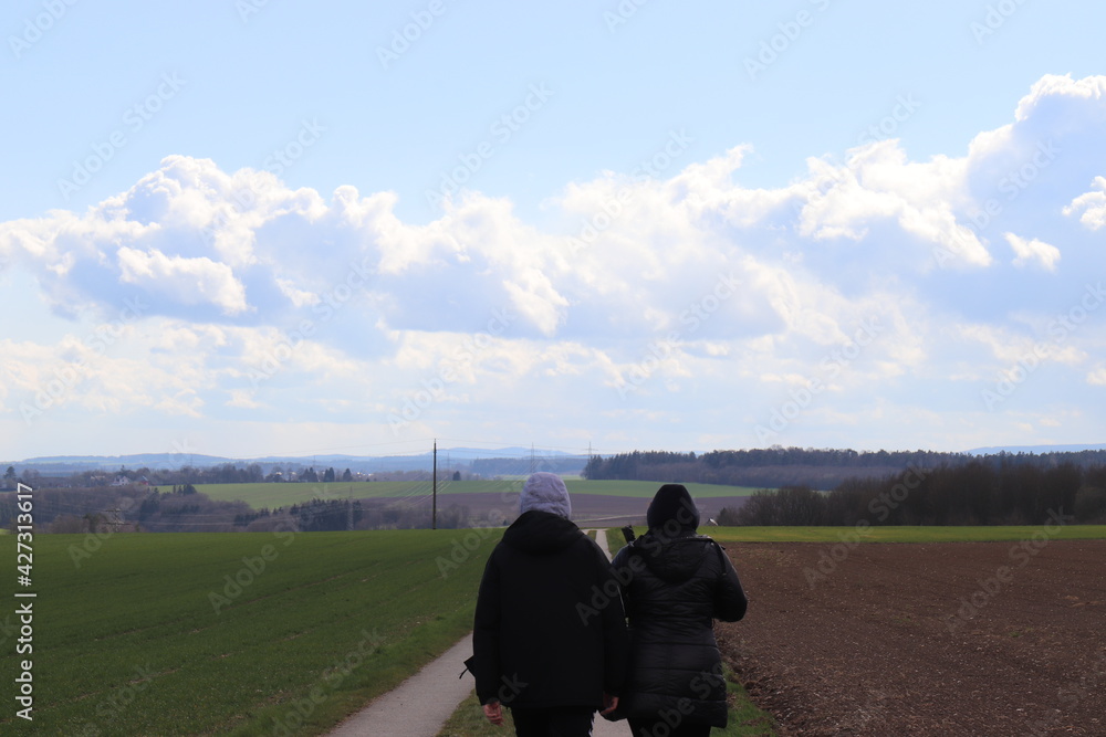 Spaziergänger auf dem Feldweg.