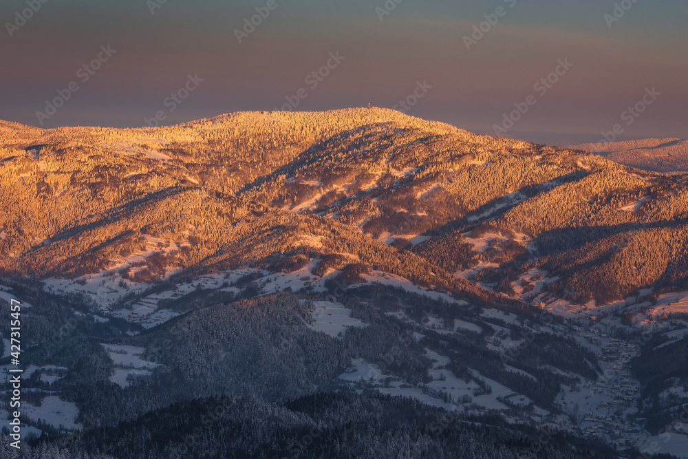 Winter morning in Gorce on the tower on the top of Lubań. A beautiful, romantic atmosphere with a view of the Pieniny Mountains, the Beskids and the Tatra Mountains.
