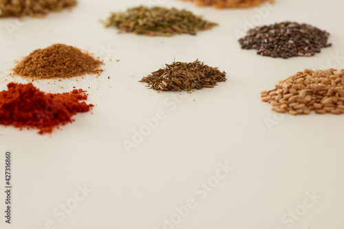 Fototapeta Naklejka Na Ścianę i Meble -  Several piles of aromatic spices of different colors