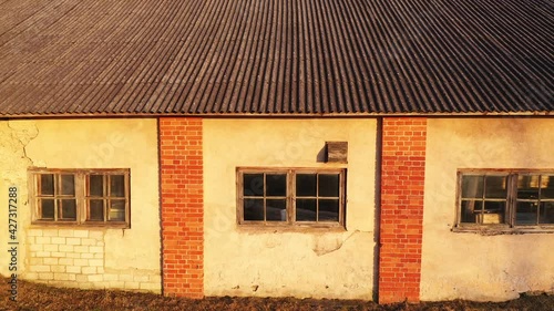 Drone View of Old Abandoned Brick Farmhouse, Revealing Dirt Road, Parallax to Left