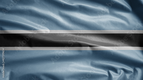 Fototapeta Naklejka Na Ścianę i Meble -  Botswana flag waving in the wind. Close up of Tswana banner blowing, soft silk.