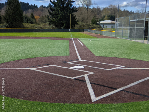 a large, empty baseball field on a bright, sunny day
