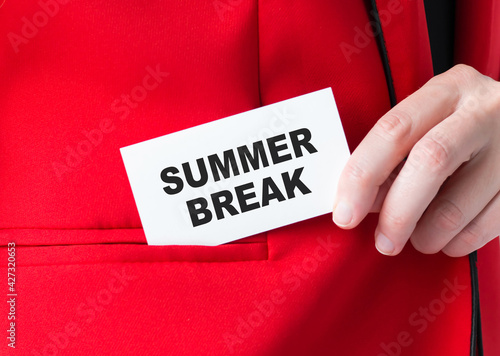 SUMMER BREAK text on a white business card in the hands of a businessman, which he puts in the pocket of a red jacket. Business, financial concept.