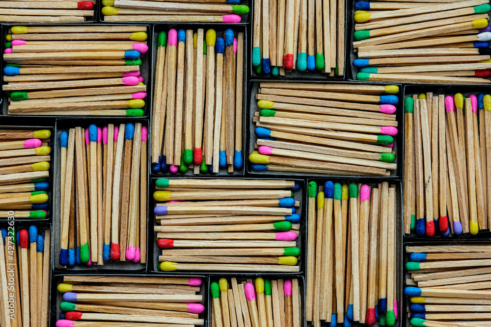 Obraz premium multicolored match sticks in boxes on a black background