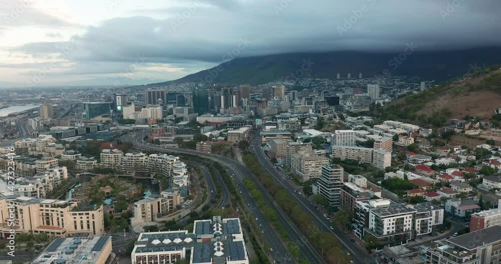 Wide aerial shot tracking forward into the city of Cape Town during a spectacular sunset with Table Mountain in the background. Wide aerial shot tracking forward into the city of Cape Town during a spectacular sunset with Table Mountain in the background.