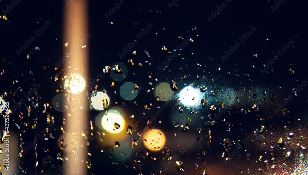 Fototapeta premium raindrops on the window on bokeh background