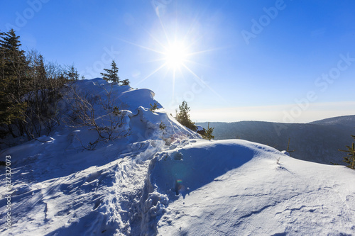Winter trip to the mountains. Mountain landscape. A snowy ridge on the top of a low mountain in the Primorsky Territory.