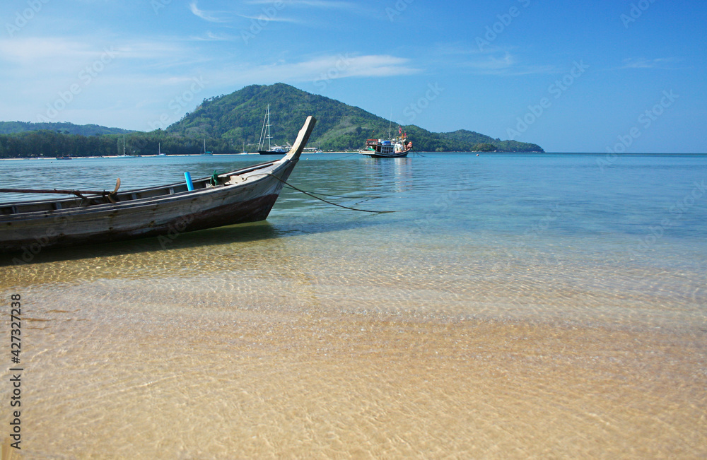 A local fishing boat on the beach., Traditional fishing boats on the coast at dawn To wait for the night fishing. A local fishing boat on the beach., Traditional fishing boats on the coast at dawn To wait for the night fishing.