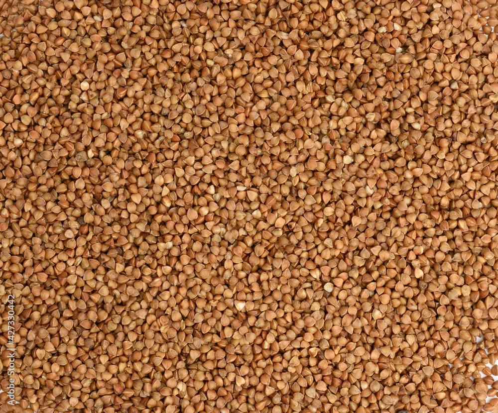 heap of uncooked buckwheat grains, top view. Full frame texture heap of uncooked buckwheat grains, top view. Full frame texture