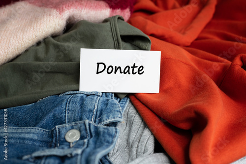 woman sorting clothes for donation at home