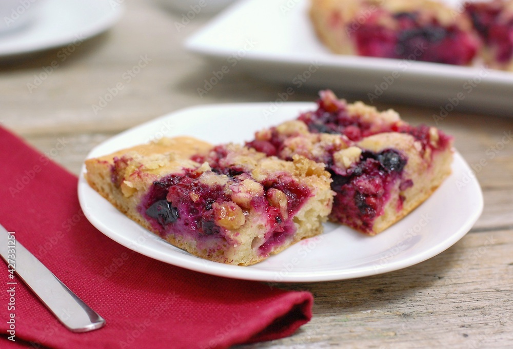 Wholegrain cake with forrest fruit on white plate Wholegrain cake with forrest fruit on white plate