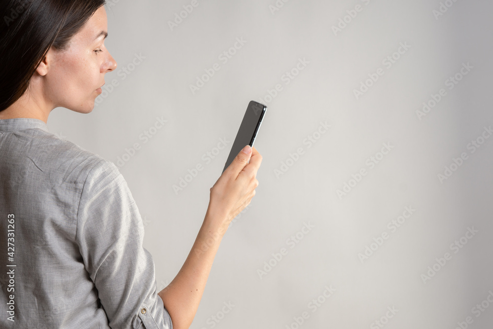 woman holds the smartphone in front of her eyes and unlocks the phone via face id. woman holds the smartphone in front of her eyes and unlocks the phone via face id.