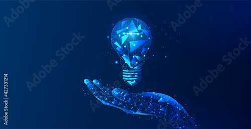 Abstract hand holding light bulb. The Internet technology triangle icon is a concept of a polygonal network. An idea, electricity, innovation, or other conceptual illustration or background.