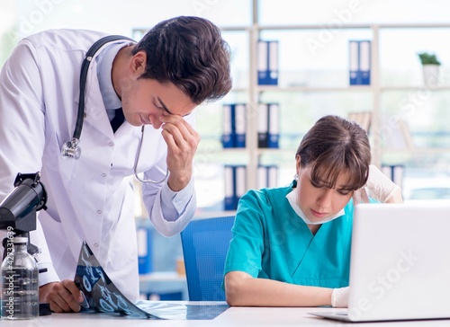 Two doctors discussing x-ray MRI image in hospital