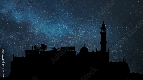 Sufi Shrine of Pir Haji Ali Shah Bukhari known as Haji Ali Dargah Mosque in Mumbai, Time Lapse by Night with Stars and Milky Way in Background photo