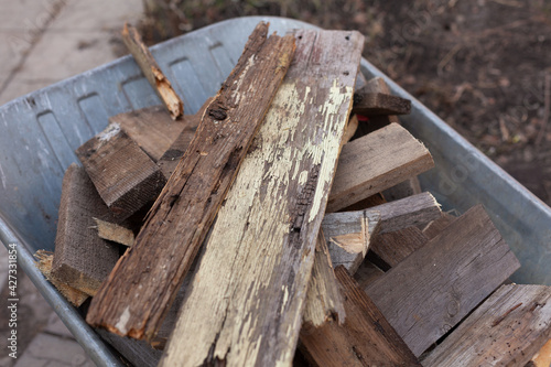 Old wooden planks laying in a wheelbarrow