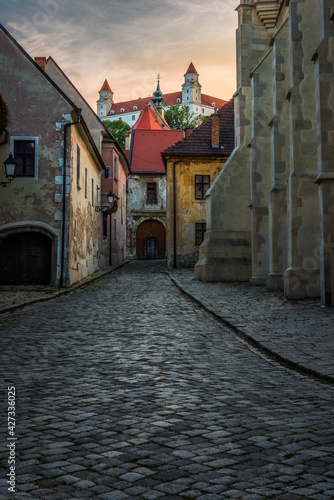 Farska Street in Historical Centre of Bratislava, Slovakia at Sunset with Bratislava Castle in Background © kaycco