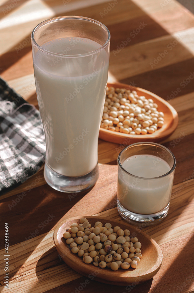 soy milk and soybeans on a wooden table soy milk and soybeans on a wooden table