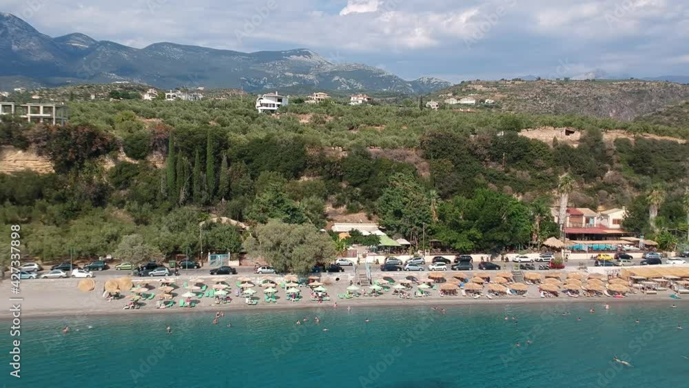 Aerial view over Santova coastal area in Messinia, Greece. Summer scenery with beautiful seaside bars and tourists in Santova near Kalamata city, Greece Aerial view over Santova coastal area in Messinia, Greece. Summer scenery with beautiful seaside bars and tourists in Santova near Kalamata city, Greece
