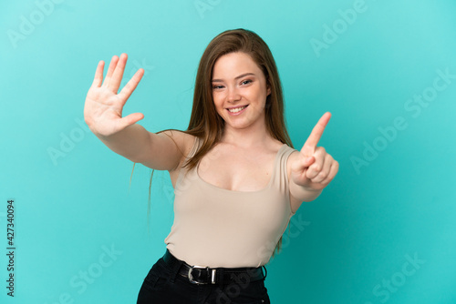 Teenager girl over isolated blue background counting six with fingers © luismolinero