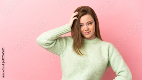 Teenager girl over isolated pink background with an expression of frustration and not understanding © luismolinero