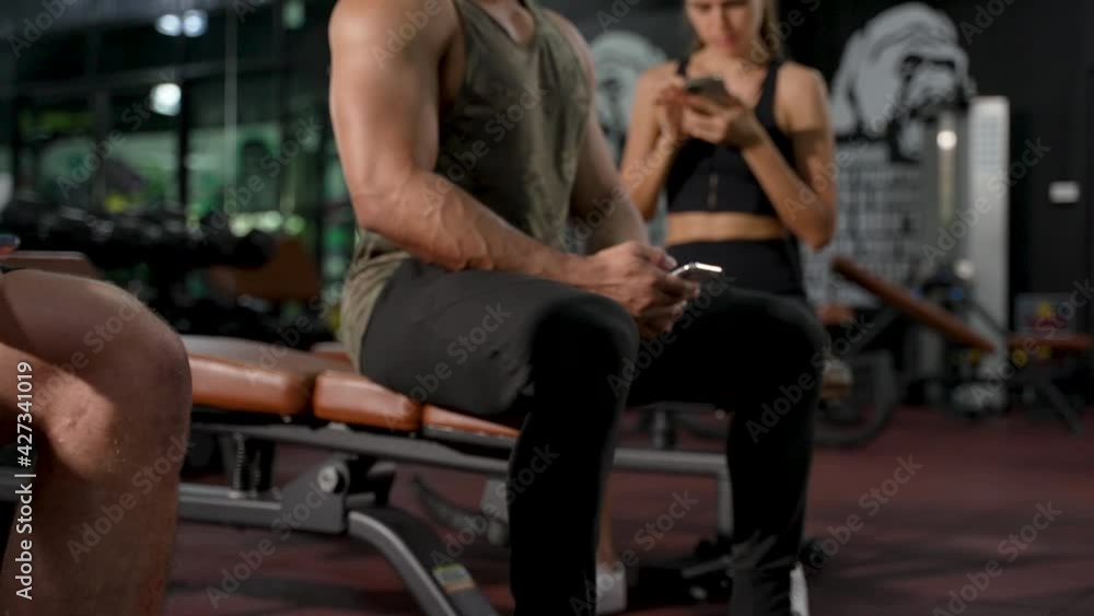 Member in Fitness gym using smartphone technology planing workout, Healthy Lifestyle bodybuilding, Athlete builder muscles lifestyle, Coach training online concept. Member in Fitness gym using smartphone technology planing workout, Healthy Lifestyle bodybuilding, Athlete builder muscles lifestyle, Coach training online concept.