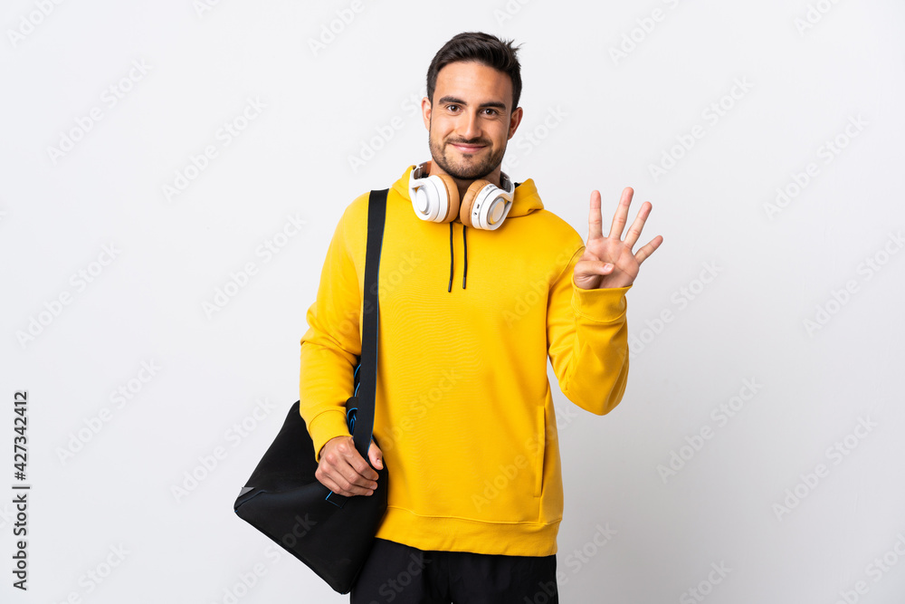Young sport man with sport bag isolated on white background happy and counting four with fingers Young sport man with sport bag isolated on white background happy and counting four with fingers