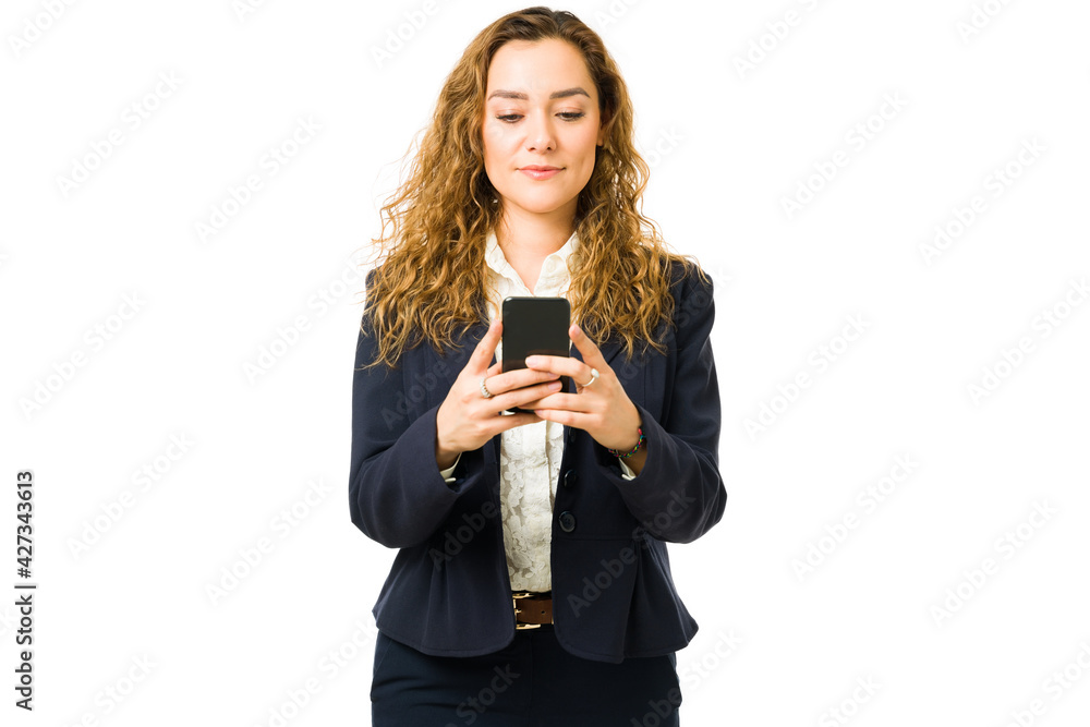 Business woman looking at the screen of her smartphone Business woman looking at the screen of her smartphone