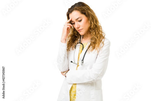 Sad young doctor thinking about negative thoughts