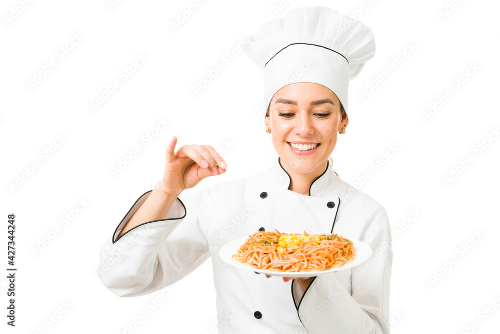 Chef finishing the dinner of a customer at the kitchen restaurant Chef finishing the dinner of a customer at the kitchen restaurant
