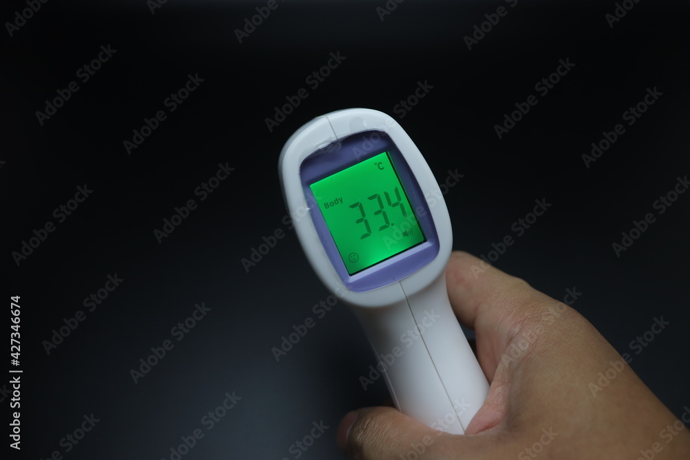 infrared thermometer in hand infrared thermometer in hand