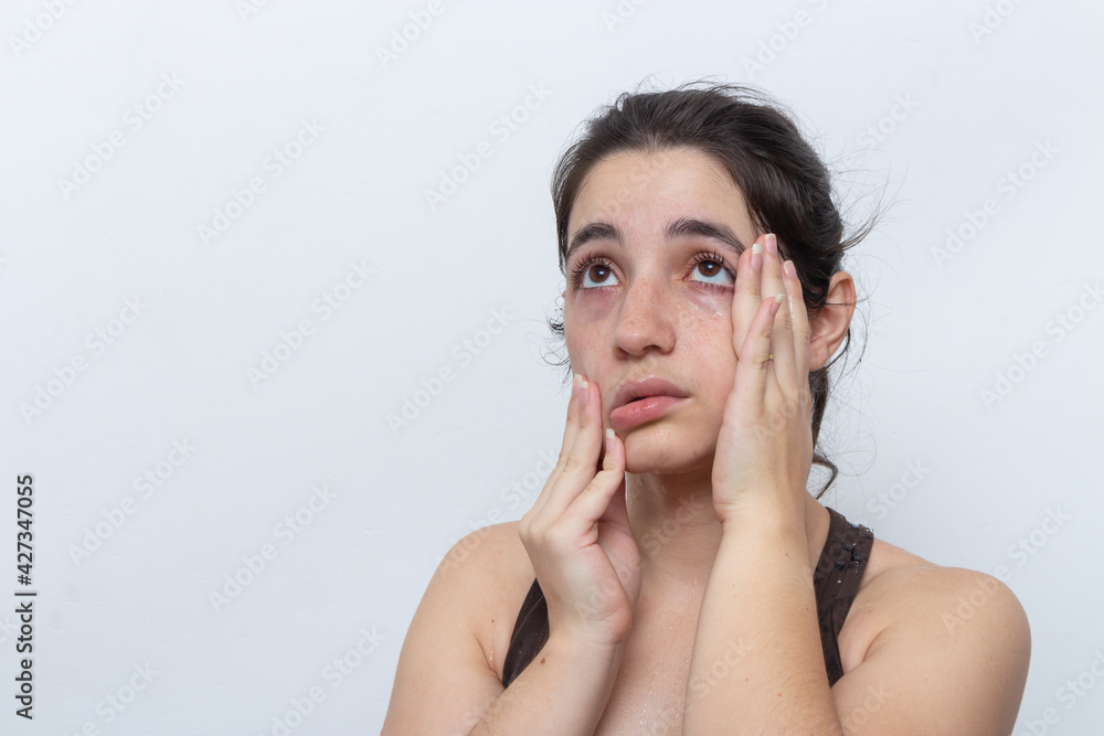 Brown tank top woman on white background with hair tied sweaty and tired Brown tank top woman on white background with hair tied sweaty and tired