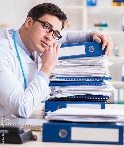 Busy doctor with too much work in hospital